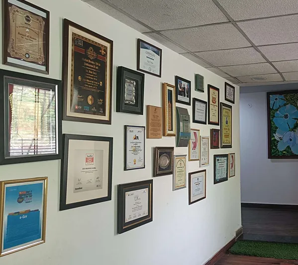 Wall of certifications and awards at the Data office